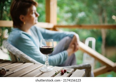 Sad Middle-aged European Woman Drinking Wine From Glass Outside Summer, Alone And Looking Away