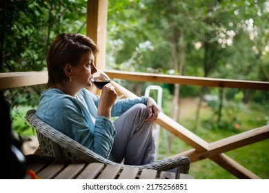 Sad Middle-aged European Woman Drinking Wine From Glass Outside Summer, Alone And Looking Away