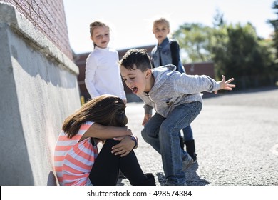 sad moment Elementary Age Bullying in Schoolyard - Shutterstock ID 498574384
