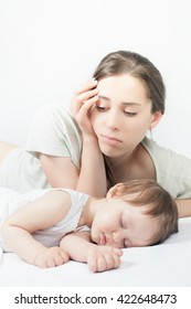 Sad Mother With Baby. Depressed Woman, Fatigue Worries. Sleeping Child. Headache