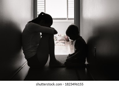 Sad mother and child sitting on the floor at home.  - Shutterstock ID 1823496155