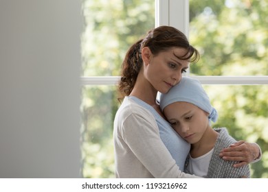 Sad Mother Hugging Sick Daughter With Cancer Wearing Blue Headscarf