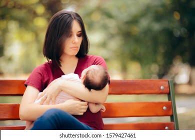 Sad Mother Suffering From Post Partum Depression Holding Baby. Young Mom Having Postnatal Baby Blues Anxiety And Stress
