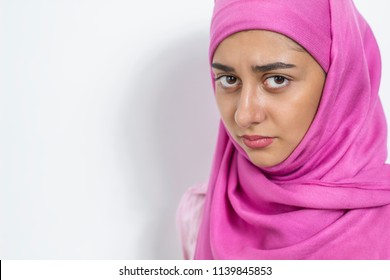 A Sad Muslim Girl In A Hijab. Arab Woman With A Sad Look. Copy Space.