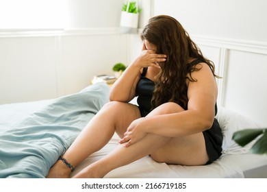 Sad Obese Woman Sitting In Bed In Pajamas While Crying Because Of Her Problems. Heartbroken Big Woman Suffering From Grief