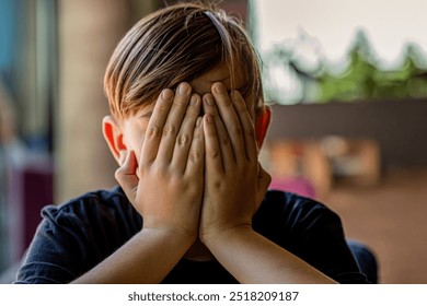 Sad offended child boy. Child abuse. Violence, domestic problem in family. Fear children hand cover face. Boy covering face with hands. Children's bullying, unhappy kid boy hands hides his face. - Powered by Shutterstock