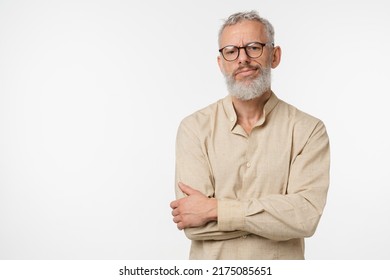 Sad offended disappointed caucasian mature middle-aged man in beige shirt and glasses feeling depression guilt negative emotions isolated in white background - Shutterstock ID 2175085651