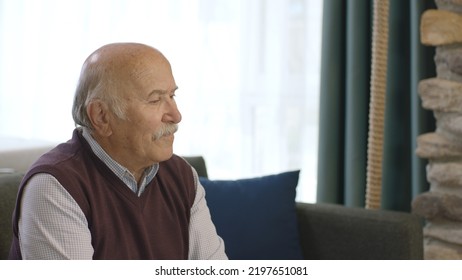 Sad Old Man Is Alone At Home. The Worried Old Man Was Lost In Thought. Loneliness Grief Concept. He Feels Anxious Alone At Home.