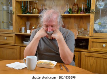 Sad Old Man
  Depressed Old Man, Self Isolating Due To COVID-19, Eating A TV Dinner Alone.  
  Lonely Old Man Eating By Himself.
  Is In Desperate Need For COVID-19 Relief Funds.