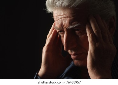 Sad Old Man On A Black Background