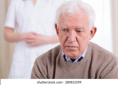 Sad Older Lonely Man Sitting At Nursing Home