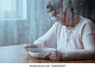 Sad Older Woman Eating Tomato Soup Alone