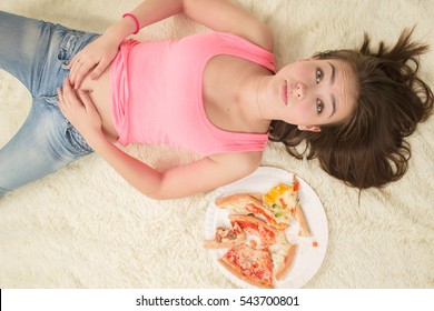 Sad Overeat Girl Lying With Pizza Pieces