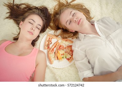 Sad Overeat Girls Lying With Pizza Pieces