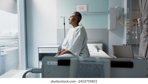 Sad, patient and thinking in hospital with window and stress, anxiety or fear of cancer, death and insurance. Senior, woman and depression in clinic with lady worried for future or mental health - Powered by Shutterstock