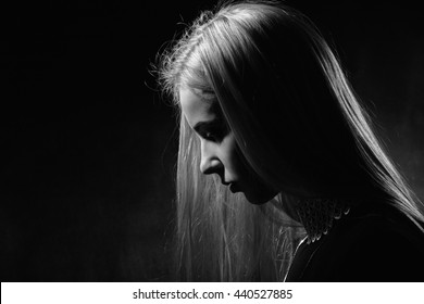 Sad Pensive Girl Profile On Black Background, Monochrome Image