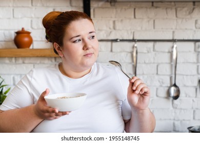 Sad Pensive Obese Fat Young Woman Eating Flakes For Breakfast. Starving Caucasian Plus Size Woman Dieting For Being In Good Shape