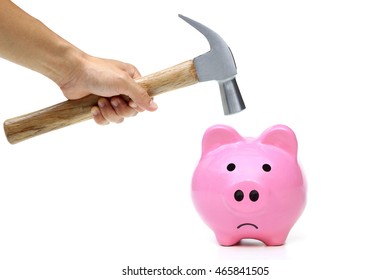 A sad pink piggy bank is about to be hit by a hammer - Powered by Shutterstock