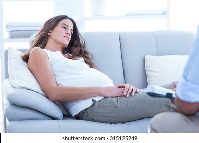 Sad Pregnant Woman Relaxing On Sofa At Home