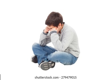 Sad Preteen Boy Sitting On The Floor Isolated On A White Background