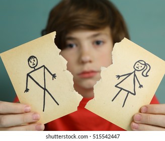 Sad Preteen Boy Unhappy About Parents Divorce, Hold Man And Woman Paper  Drawing Torn Apart