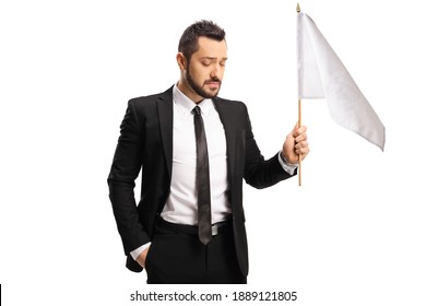 Sad Professional Man In A Suit Holding A White Flag Isolated On White Background