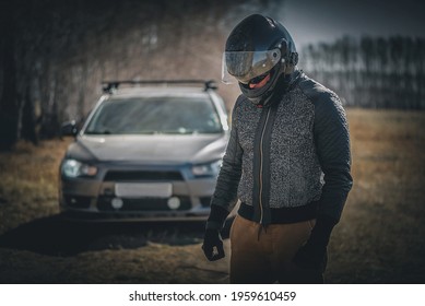 Sad Rally Driver With His Head Down Is Standing On The Road. Lose The Race Concept.