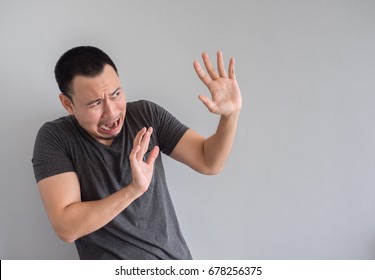 Sad And Scared Expression Face Of Asian Man In Black T-shirt.