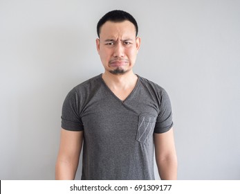 Sad And Scared Expression Face Of Asian Man In Black T-shirt.