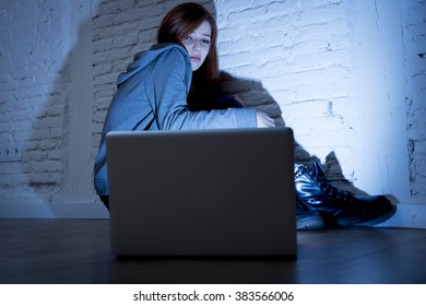 Sad And Scared Female Teenager With Computer Laptop Suffering Cyberbullying And Harassment Being Online Abused By Stalker Or Gossip Feeling Desperate And Humiliated In Cyber Bullying Concept