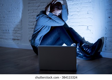 Sad And Scared Female Teenager With Computer Laptop Suffering Cyberbullying And Harassment Being Online Abused By Stalker Or Gossip Feeling Desperate And Humiliated In Cyber Bullying Concept