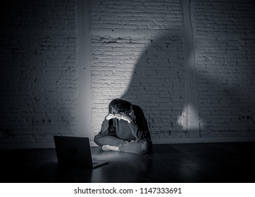 Sad And Scared Female Young Woman With Computer Laptop Suffering Cyberbullying And Harassment Being Online Abused By Stalker Or Gossip Feeling Desperate And Humiliated In Cyber Bullying Concept.