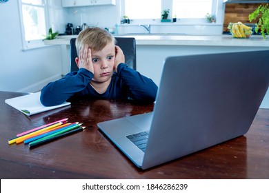 Sad School Boy Watching Virtual Lesson In Online Education Classes Feeling Bored And Depressed At Home In Self-isolation. COVID-19 Second Wave, Quarantine, School Closures And Remote Learning Concept.