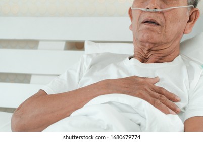 Sad senior man lying on the hospital bed and with a nasal breathing tube for treatment respiratory. Concept of Health care for the elderly, quarantine coronavirus (COVID-19) - Shutterstock ID 1680679774