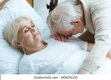 Sad Senior Man And Senior Woman In Coma In Hospital