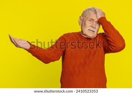 Sad senior old man feeling hopelessness loneliness, nervous breakdown, loses becoming surprised by lottery results, bad fortune, loss unlucky news. Mature grandfather isolated on yellow background
