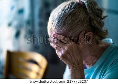 Sad senior old woman. Lonely from loss or sick with headache. Upset patient in retirement home with stress or pain. Alzheimer, depression, senility or dementia. Disorder, migraine or insomnia.