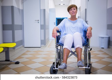 Sad senior patient sitting on a wheelchair in hospital - Powered by Shutterstock