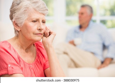 Sad senior woman after arguing with husband in living room - Powered by Shutterstock