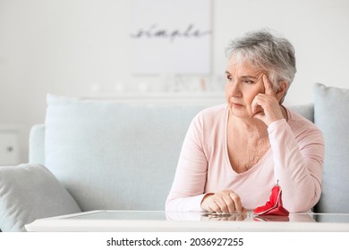 Sad Senior Woman Counting Money At Home