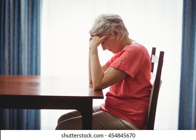 Sad Senior Woman Sitting At A Table In A Retirement Home