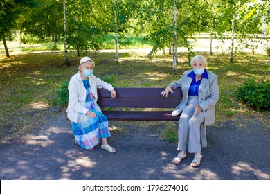 The Sad Senior Women In Social Distancing Sitting At Park. The Covid-19, Health, Safety And Pandemic Concept