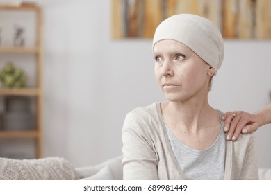 Sad Sick Woman With Lung Cancer Sitting At Home With Friend