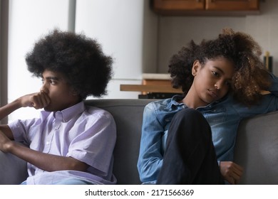 Sad Silent African Teenagers Couple After Fight Sit Apart On Sofa, Avoid Talk, Think About Break Up, Troubles In Relations, Having Problems In Relationships, First Love, Quarrels, Heartbreak Concept