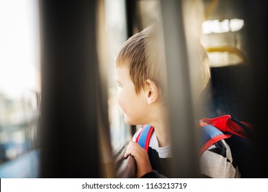 Sad Small Boy Is Looking Thru Bus Window.