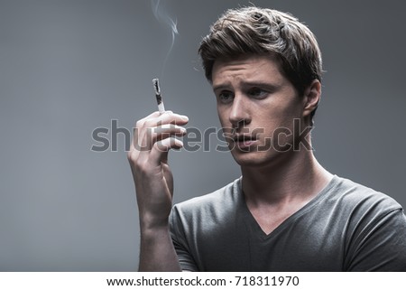 Sad smoker thinking about his nicotine addiction