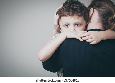 sad son hugging his mother at home. Concept of couple family is in sorrow.