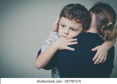 sad son hugging his mother at home. Concept of couple family is in sorrow.
