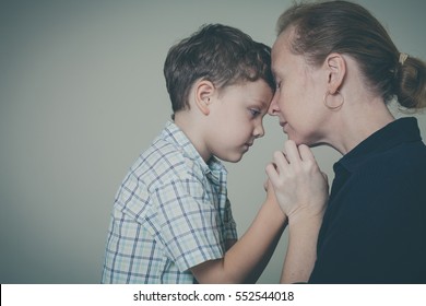 Sad Son Hugging His Mother At Home. Concept Of Couple Family Is In Sorrow.