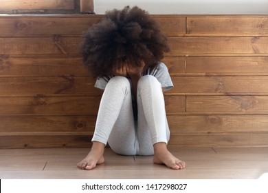 Sad Stressed Little African American Girl Crying, Upset Lonely Bullied Child Feels Abandoned Abused, Preschool Black Orphan Kid In Tears Sit Alone On Floor, Children Abuse, Unhappy Childhood Concept